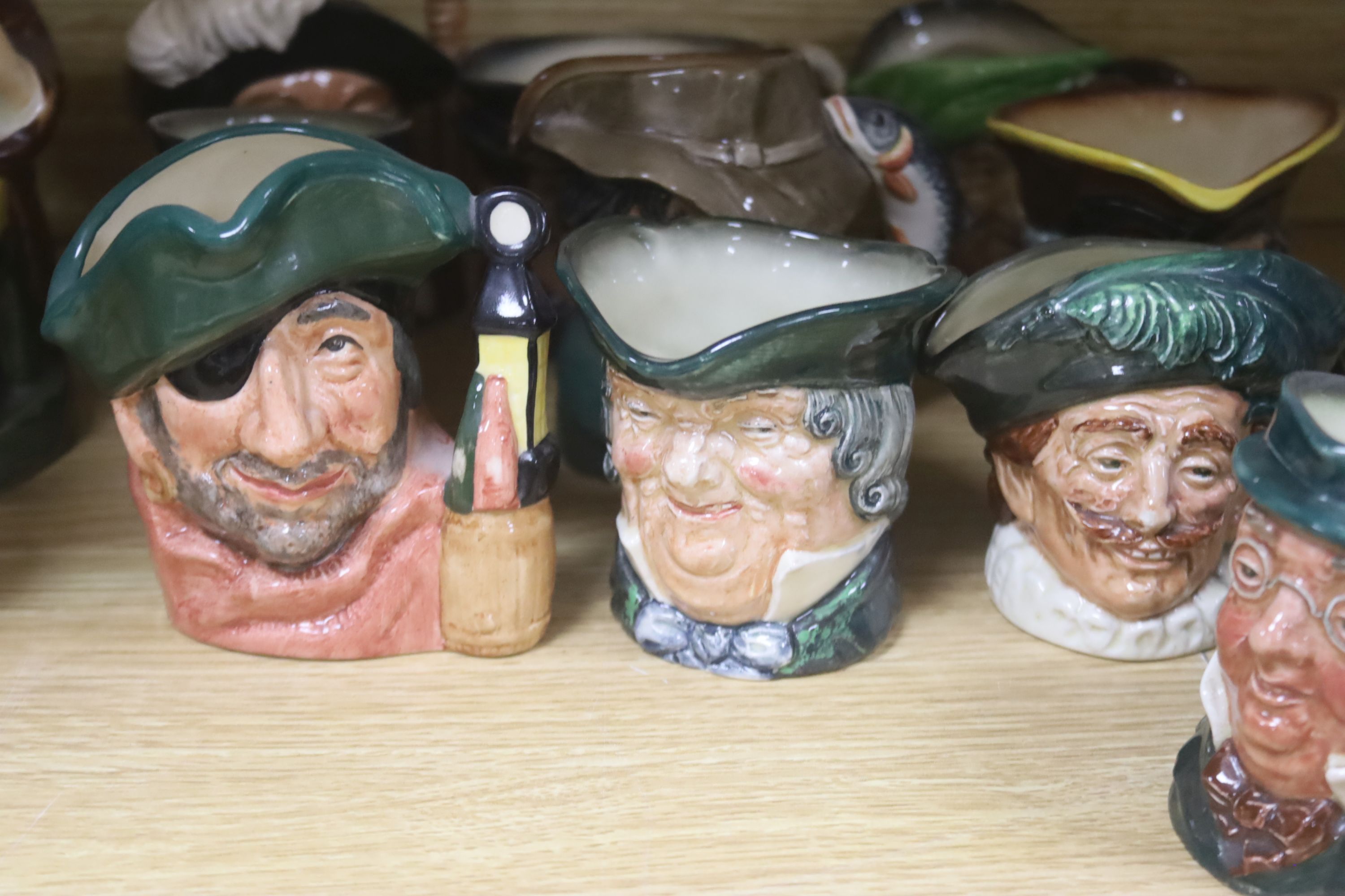 Twelve Royal Doulton character 'small' mugs and two Toby jugs